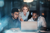 People working together at a laptop looking at the screen