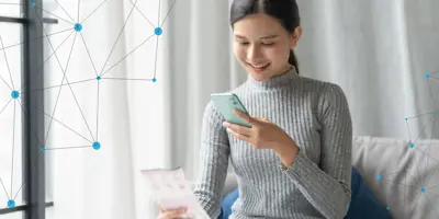 A young woman scanning a document with her mobile phone