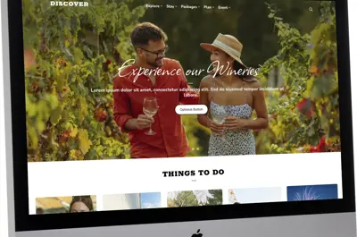 desktop computer with a tourism website on the screen